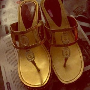 Gold wedge heels by baby phat.